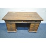 AN EARLY 20TH CENTURY OAK PEDESTAL DESK, with four frieze drawers, and four drawers to each