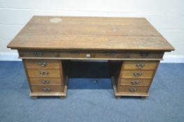 AN EARLY 20TH CENTURY OAK PEDESTAL DESK, with four frieze drawers, and four drawers to each