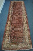 A 20TH CENTURY IRANIAN RED PATTERNED CARPET RUNNER, 319cm x105cm (condition:-some low pile)