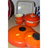 A SET OF LE CREUSET BURNT ORANGE OVENWARE, comprising a 1.5 litre casserole (chipped lid), two