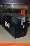 AN AMERICAN MAIL BOX, painted black, with red flag, one end reading 'US Mail, approved by the