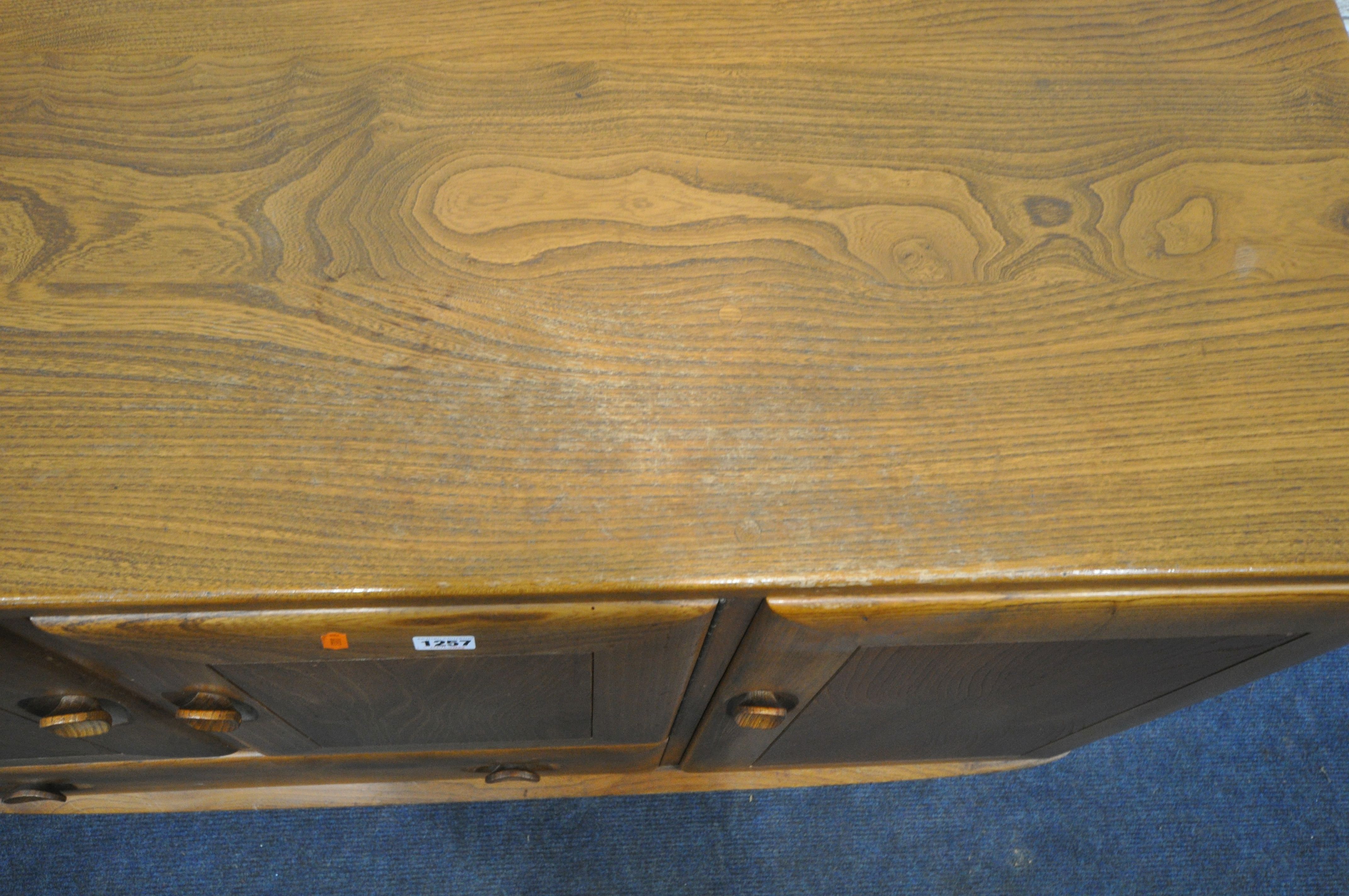 AN ERCOL BLONDE ELM SIDEBOARD, with double cupboard doors over a single drawer flanked by a single - Image 3 of 5