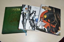 THREE GAMING BOOKS, STICKERS AND POSTCARDS, includes the Portal 2 Collector's Reading Guide, The Art
