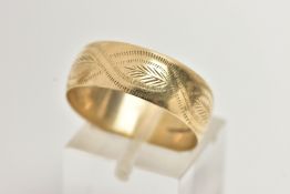A 9CT GOLD BAND RING, a yellow gold wide band with an engraved foliage pattern detail, approximate