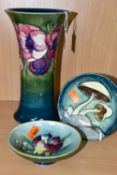 THREE PIECES OF MOORCROFT POTTERY, comprising an Anemones pattern vase of flared form, tubelined