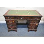 A REPRODUCTION MAHOGANY TWIN PEDESTAL DESK, with green and tooled leather writing surface, and