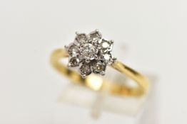 A MODERN DIAMOND CLUSTER RING, set with a principal round brilliant cut diamond, surrounded by eight