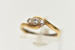 A DIAMOND THREE STONE RING, three single cut diamonds, prong set, yellow gold bypass mount,