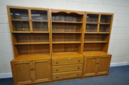 A SET OF THREE HAND CRAFTED SOLID ELM BOOKCASES, comprising of two sections with double glazed