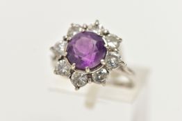AN AMETHYST AND DIAMOND CLUSTER RING, set with a principal amethyst, measuring approximately 8.08