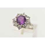 AN AMETHYST AND DIAMOND CLUSTER RING, set with a principal amethyst, measuring approximately 8.08