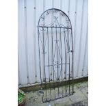 A WROUGHT IRON ARCH GARDEN GATE with foliate detailing width 85cm height 210cm