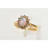 A 18CT GOLD OPAL CLUSTER RING, a single cabochon set with a surround of round brilliant cut