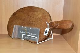 A ROBERT 'MOUSEMAN' THOMPSON CARVED OAK CHEESEBOARD OF KIDNEY FORM WITH CARE CARD, bears carved
