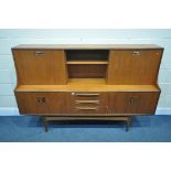 A MID CENTURY G PLAN FRESCO TEAK HIGHBOARD, upper section with a sliding door, and fall front