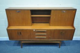 A MID CENTURY G PLAN FRESCO TEAK HIGHBOARD, upper section with a sliding door, and fall front