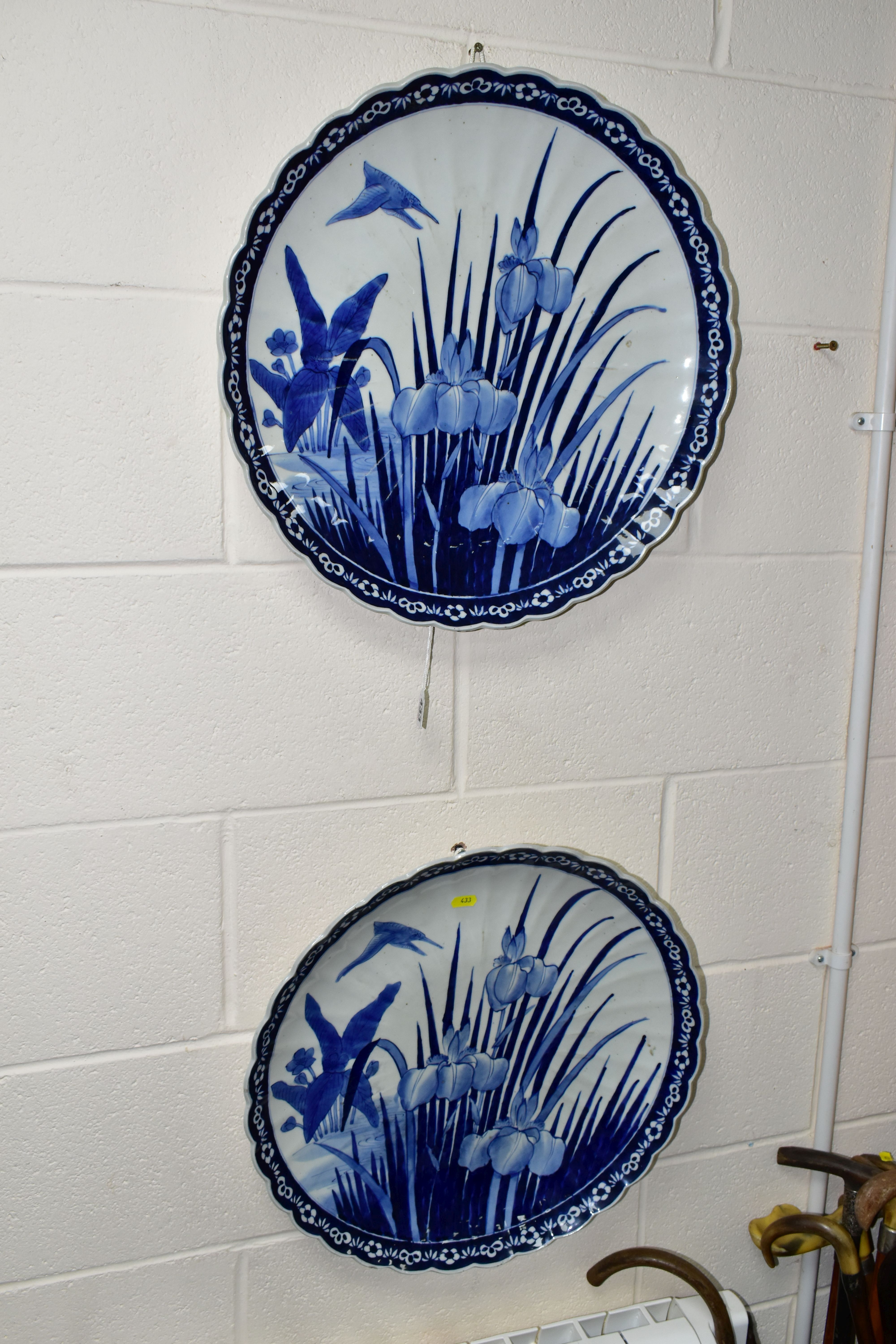 A PAIR OF LATE 19TH CENTURY JAPANESE BLUE AND WHITE PORCELAIN CHARGERS, wavy rims and fluted