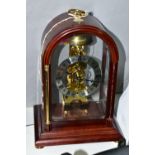 A HERMLE SKELETON MANTEL CLOCK, together with pendulum and key, approximate height 30cm