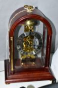 A HERMLE SKELETON MANTEL CLOCK, together with pendulum and key, approximate height 30cm