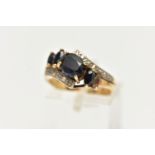 A 9CT GOLD SAPPHIRE AND DIAMOND DRESS RING, set with an oval dark sapphire and marquise sapphire (