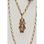 A 9CT GOLD RAG DOLL PENDANT AND CHAIN, articulated rag doll pendant, set with three rubies and