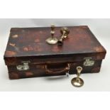 AN EARLY 20TH CENTURY BROWN LEATHER DRESSING SUITCASE IN WORN CONDITION, containing five silver