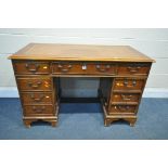 A 20TH CENTURY YEW WOOD TWIN PEDESTAL DESK, with a tanned leather writing surface, eight drawers,