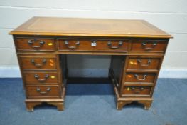 A 20TH CENTURY YEW WOOD TWIN PEDESTAL DESK, with a tanned leather writing surface, eight drawers,