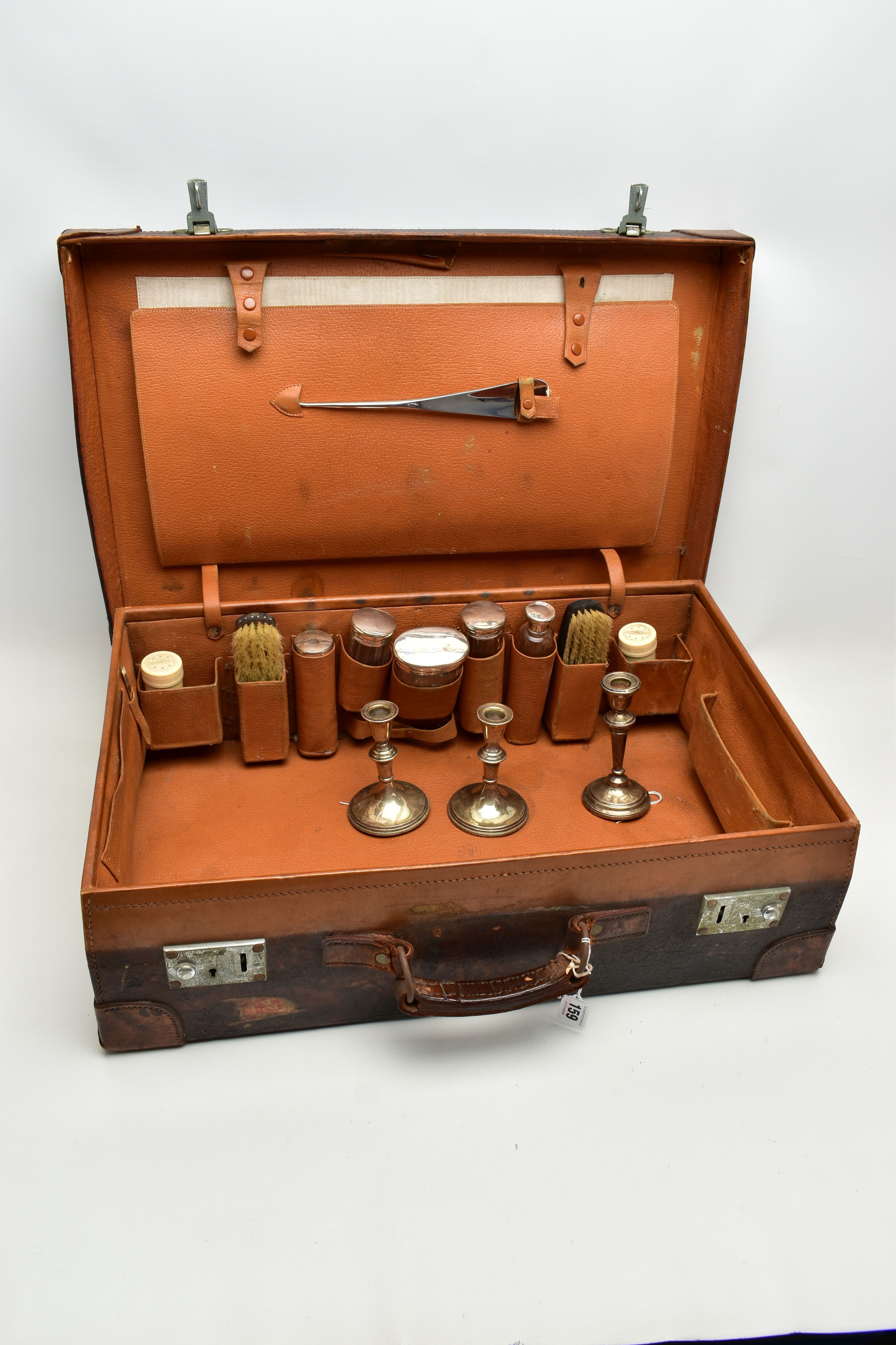 AN EARLY 20TH CENTURY BROWN LEATHER DRESSING SUITCASE IN WORN CONDITION, containing five silver - Image 4 of 9
