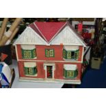 A CIRCA 1950'S DOLLS HOUSE, POSSIBLY BY TRIANG, converted to electric lighting at some point,