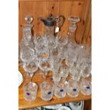 A GROUP OF CUT CRYSTAL GLASSWARES, thirty four pieces, to include a claret jug having plated