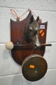 A WALL MOUNTED BRASS DINNER GONG, in the form of a horse head, with a beater