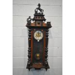 A LATE 19TH CENTURY WALNUT VIENNA WALL CLOCK, with two carved horse pediments, enamel dial with