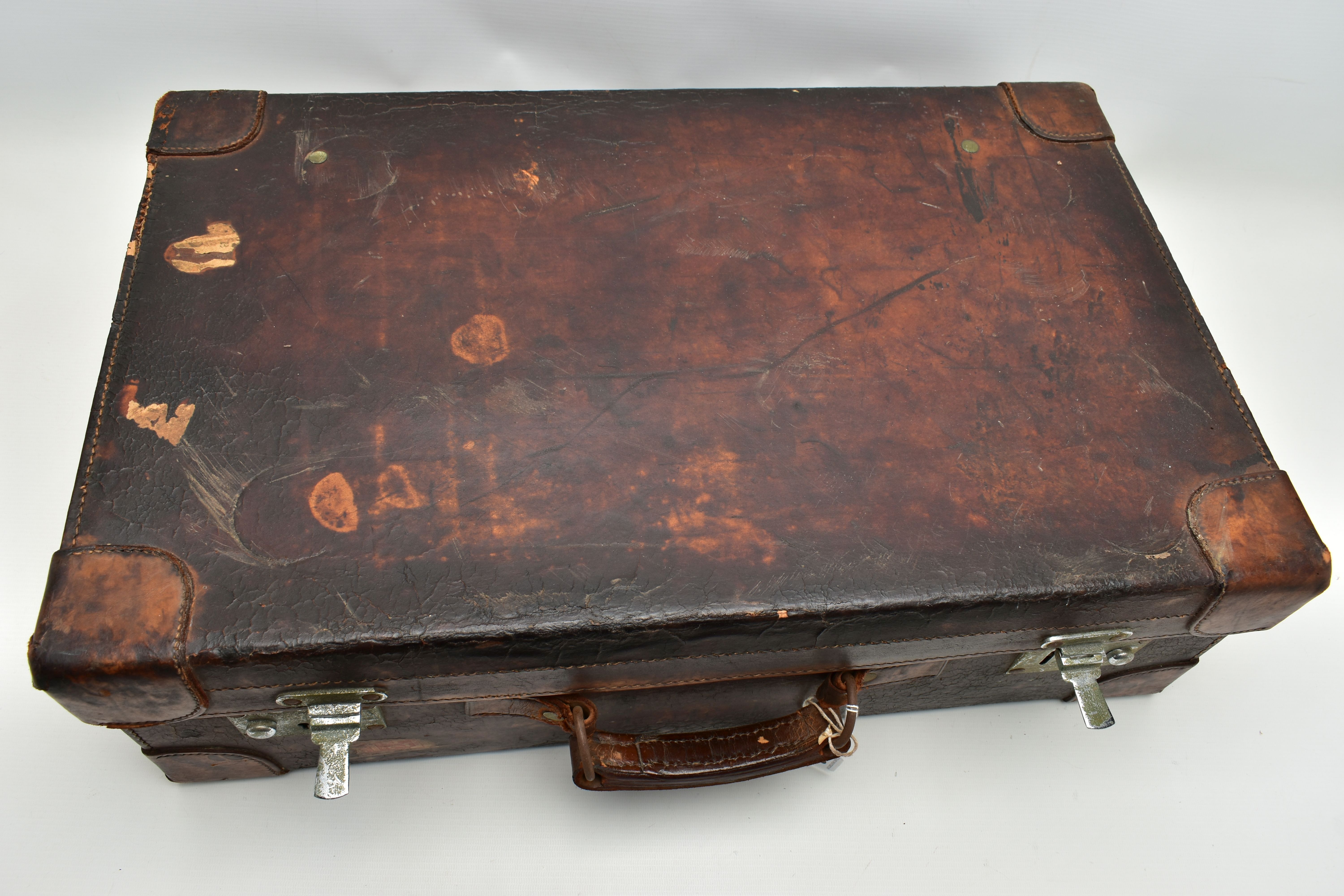 AN EARLY 20TH CENTURY BROWN LEATHER DRESSING SUITCASE IN WORN CONDITION, containing five silver - Image 8 of 9