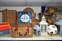 A GROUP OF WICKER PICNIC HAMPERS AND GARDEN LANTERNS, comprising three wicker picnic hampers, one
