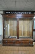 A LARGE LATE 19TH CENTURY MAHOGANY DISPLAY CABINET, overhanging cornice, fitted with two glazed