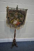 A VICTORIAN MAHOGANY POLE SCREEN, with a floral needlework hanging tapestry, on turned shaft, with