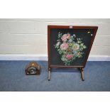A MAHOGANY FRAMED TILT TOP NEEDLE WORK FIRESCREEN/TABLE, and a mantel clock (condition - domed