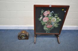 A MAHOGANY FRAMED TILT TOP NEEDLE WORK FIRESCREEN/TABLE, and a mantel clock (condition - domed