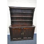 A 20TH CENTURY PINE DRESSER, the top with a three tier plate rack, base with two cupboard doors,