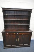 A 20TH CENTURY PINE DRESSER, the top with a three tier plate rack, base with two cupboard doors,