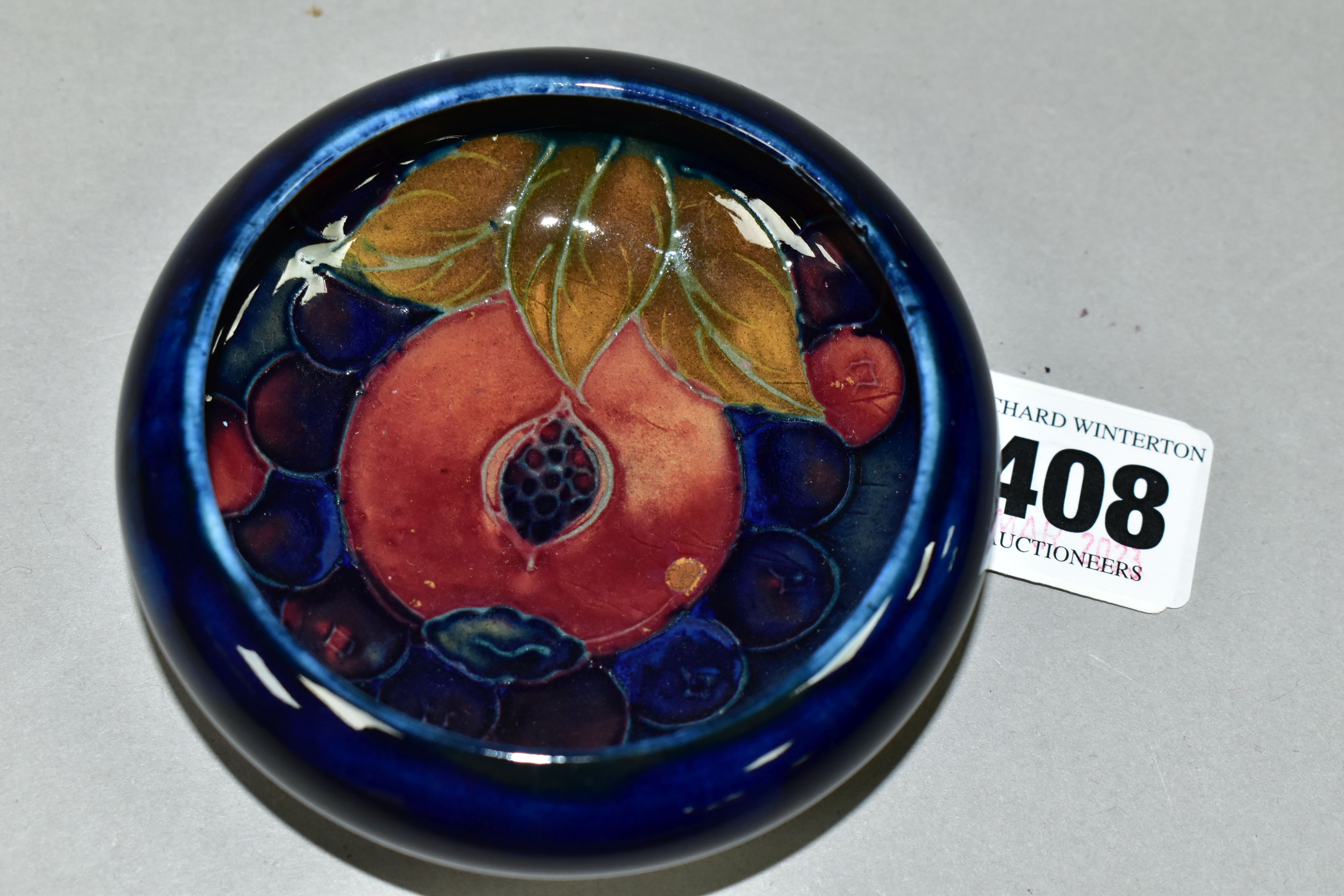 A MOORCROFT POTTERY CIRCULAR SHALLOW BOWL WITH INVERTED RIM DECORATED WITH POMEGRANATE PATTERN ON - Image 2 of 3