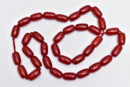 A CHERRY AMBER BAKELITE BEAD NECKLACE, designed with a single row of thirty-five barrel shape beads,