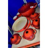 A GROUP OF LE CREUSET COOKWARES, comprising a cast iron round casserole dish with cover, diameter