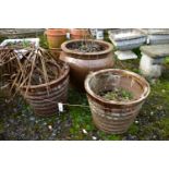 A BROWN GLAZED CIRCULAR PLANT PLANTER, of a ribbed tapered design, diameter 47cm x height 40cm,