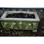 A WEATHERED COMPOSITE RECTANGULAR PLANTER, depicting various cherubs, on twin separate bases, length