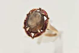 A 9CT GOLD SMOKY QUARTZ RING, designed with a claw set, oval cut smoky quartz, within an openwork