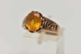 A 9CT GOLD GEMSTONE RING, designed with a six claw set, oval cut orange stone assessed as