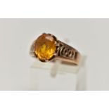 A 9CT GOLD GEMSTONE RING, designed with a six claw set, oval cut orange stone assessed as