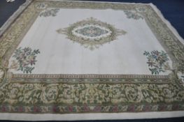 A X LARGE ORIENTAL WOLLEN RUG, cream and green ground, with a central medallion, 456cm x 368cm (